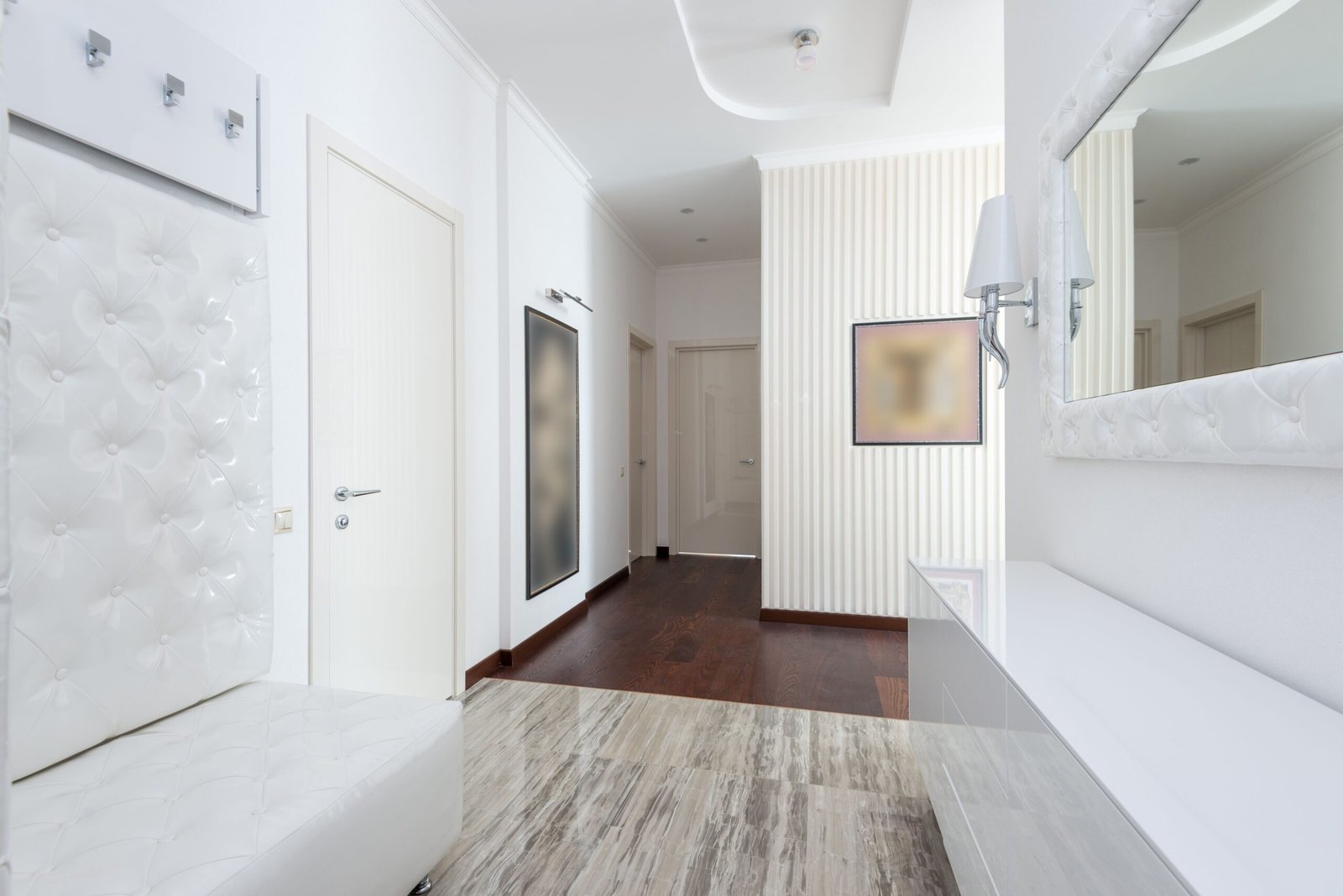 narrow apartment hallway with a slim storage cabinet against one wall
