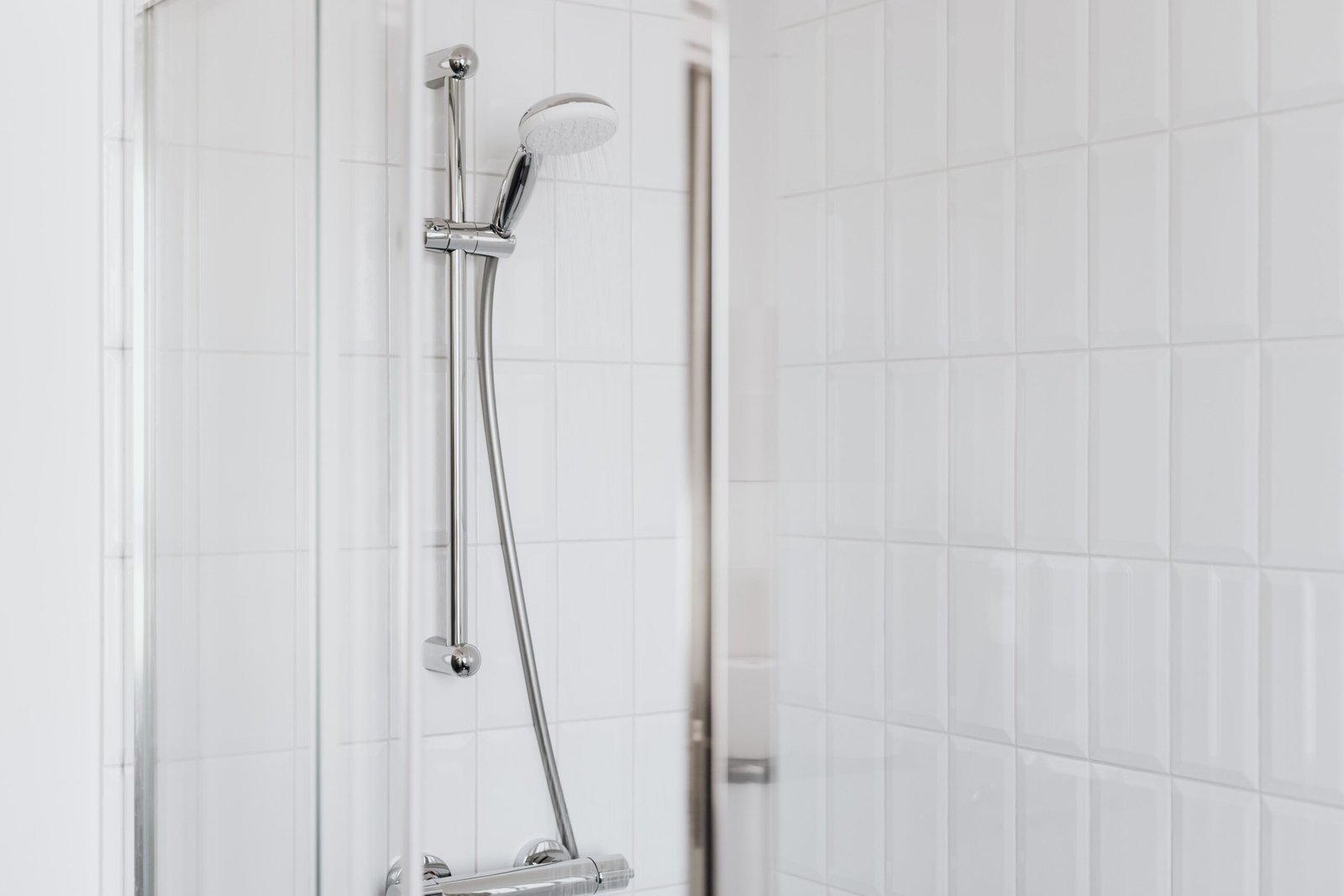 tiled wet room with no shower screen and a floor drain